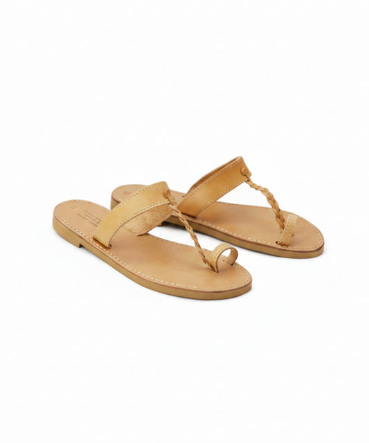 Pair of tan sandals on a white background